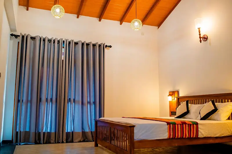 Upper-floor bedroom with full-length curtains and pendant lights