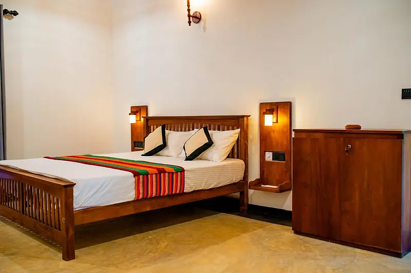 Spacious upper bedroom with king bed and teak cabinet