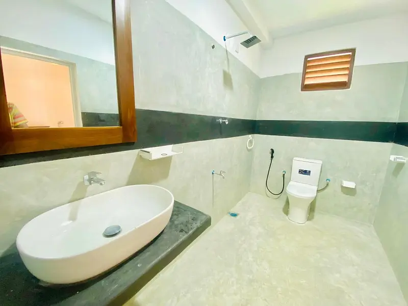 Bathroom with stone counter, vessel basin and walk-in shower