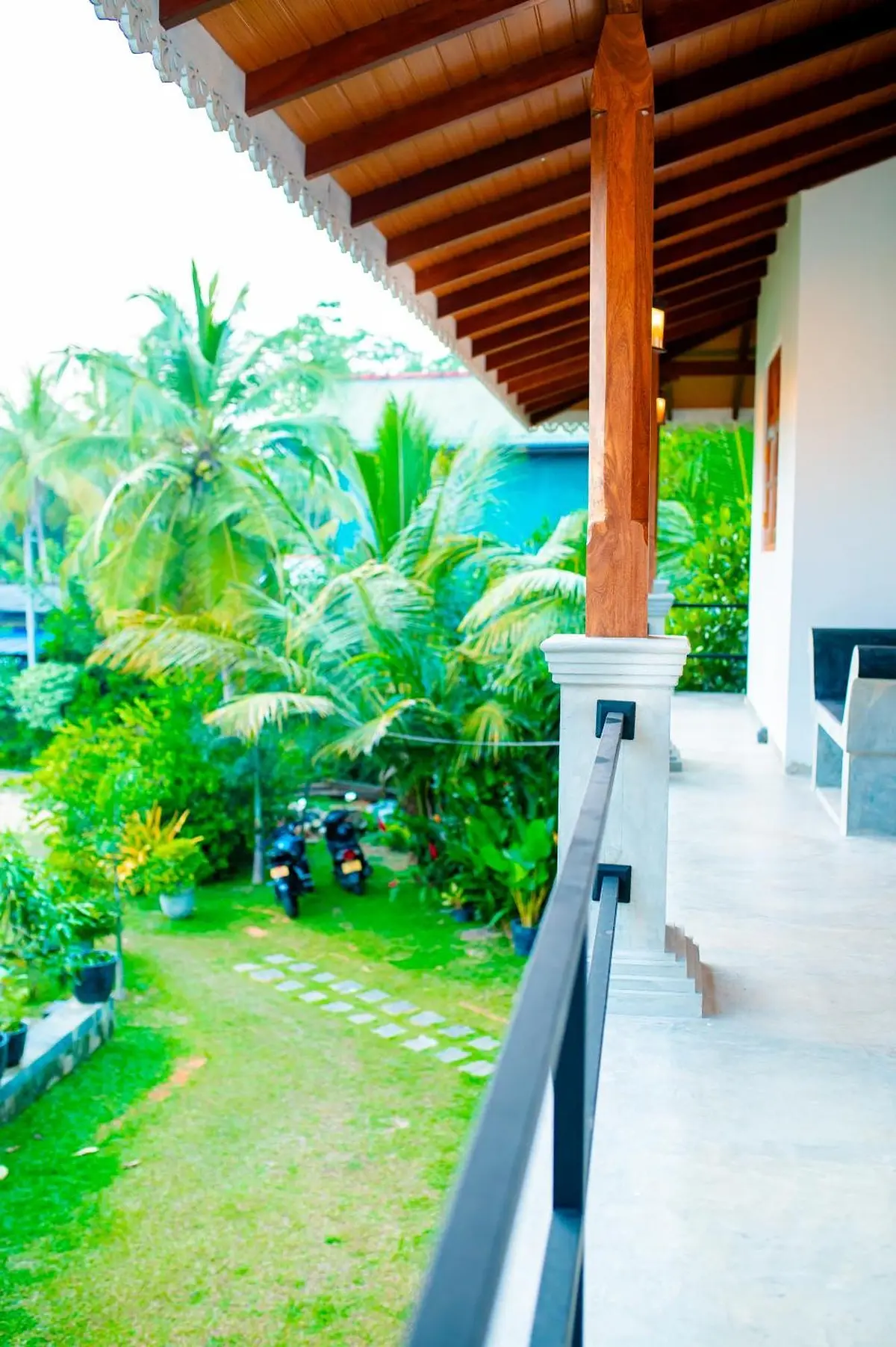 View from the upper veranda down to the lawn and coconut palms
